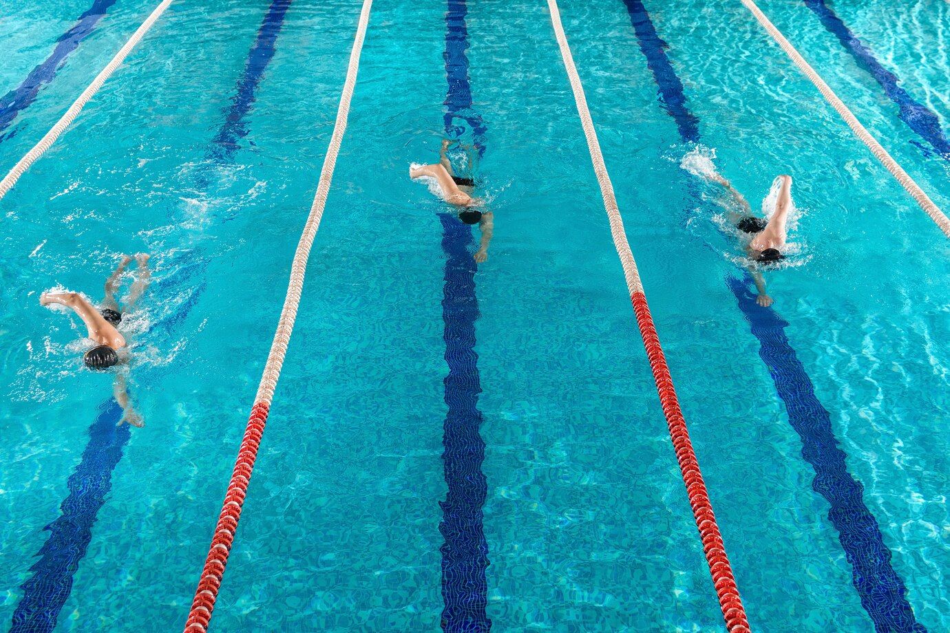 three-male-swimmers-racing-against-each-other_171337-7582.jpg